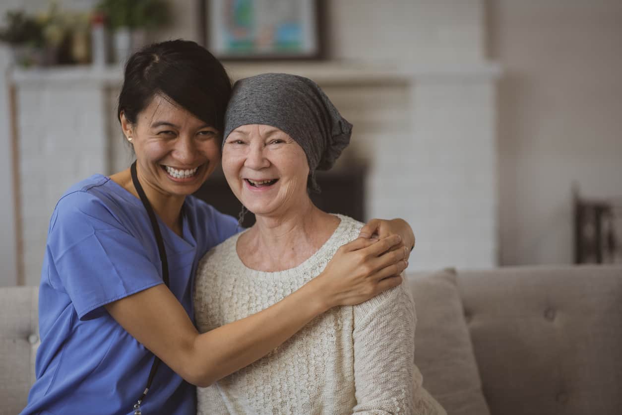 Nurse Hugging Her Cancer Patient stock photo